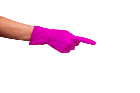 Female hand in purple medical glove showing way the index finger. One arm isolated on a white background.の写真素材