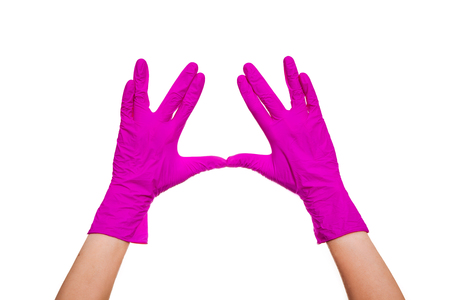 Female hands in purple medical gloves on a white background.の写真素材