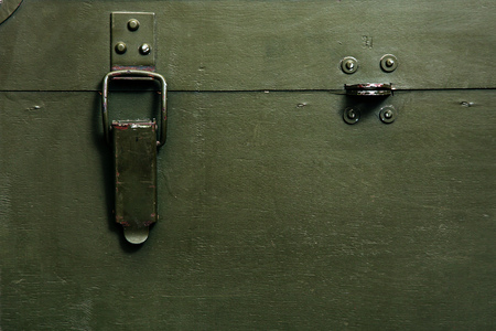 A green military storage box for ammunition. Green box from the war with scratches and locks in front.の写真素材