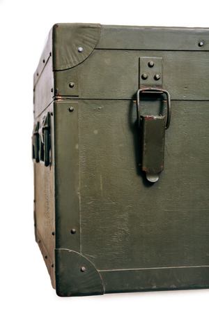 A green military storage box for ammunition. Green box from the war with scratches and locks in front.の写真素材