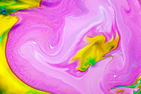 Abstract colored pink, yellow and green acrylic paints. View of macro world through the microscope.の写真素材
