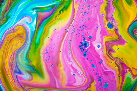 Abstract colored pink, yellow and green acrylic paints. View of macro world through the microscope.の写真素材