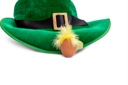 A St. Patrick's day costume hat of a leprechaun. Irish green hat on a white background with egg.の写真素材