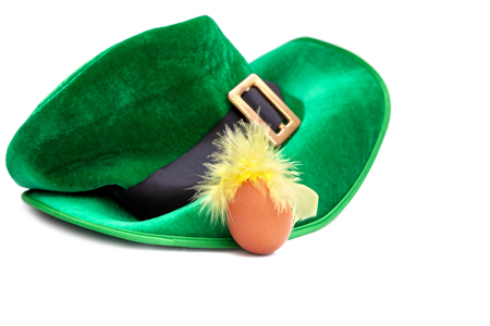 A St. Patrick's day costume hat of a leprechaun. Irish green hat on a white background with egg.の写真素材