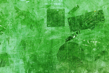 Vintage wall with traces of black and green stickers. Green old background with pattern.の写真素材