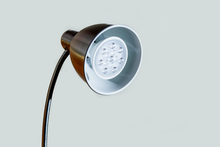 Close-up of a LED lamp white and red color. Round table lamp with a new technology lamp on white background.の写真素材