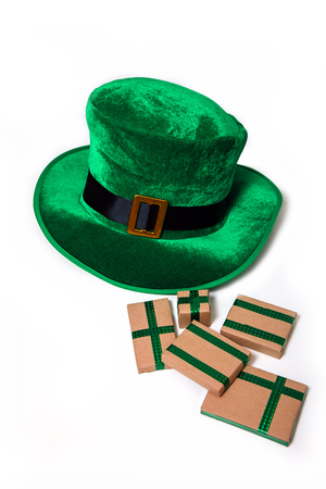 A St. Patrick's day costume hat of a leprechaun. Irish green hat with gifts on a white background.の写真素材