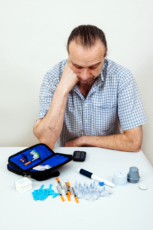 Man testing glucose level with a digital glucometer, sensor checkup glucose levels without blood. Diabetes treatment.の写真素材