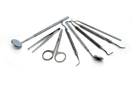 Dental equipment and instruments are on a white table.の写真素材