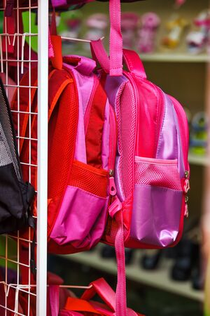 Many pink backpacks on the shelf in the supermarket.の写真素材