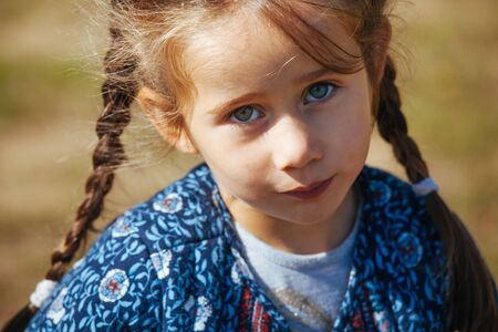 Happy girls enjoy good weather and sunlight. Beautiful kids laying and play with each other.の写真素材