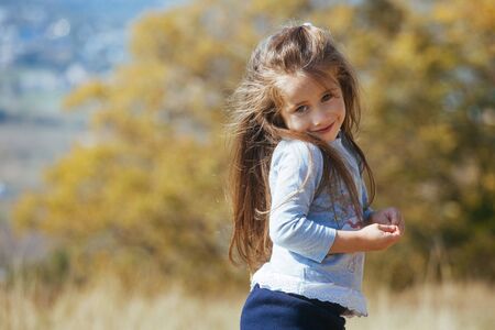 Happy girls enjoy good weather and sunlight. Beautiful kids laying and play with each other.の写真素材