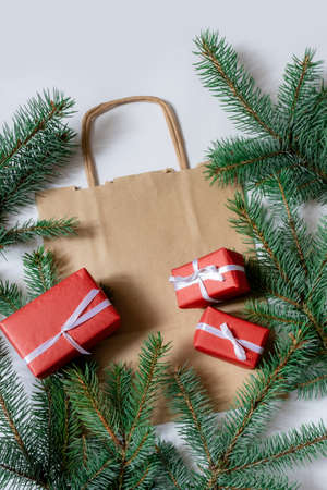 Christmas Tree Branches with bag and holiday gifts on the white background.の写真素材