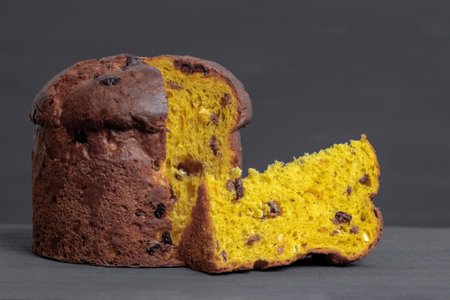 Easter panetone italian with a cut off piece on the gray background.の写真素材