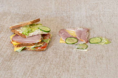 Fallen and spoiled sandwich on the sofa with dirty stain.の写真素材