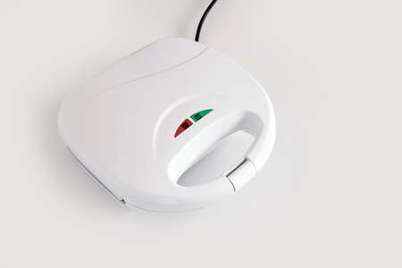 White toster for sandwiches on the white table, close-up, copy space.の写真素材
