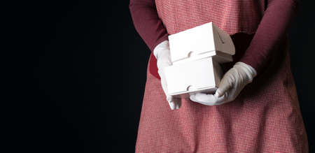 box white delivery shopping bag pack red hold hand copy space black backgroundの写真素材