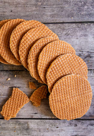 Traditional Holland waffles with caramel on the wooden background, top view.の写真素材
