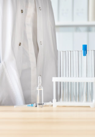 Test tube, ampoule, syringe on the table, concept of global vaccination.の写真素材