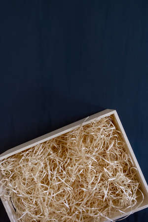 Straw into storage box for wine on the blue background, delivery service.の写真素材