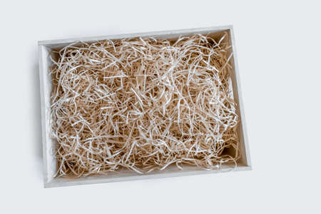 Straw into storage box for wine on the white background, delivery service.の写真素材