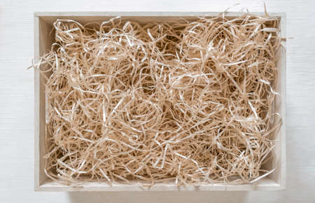 Straw into storage box for wine on the white background, delivery service.の写真素材