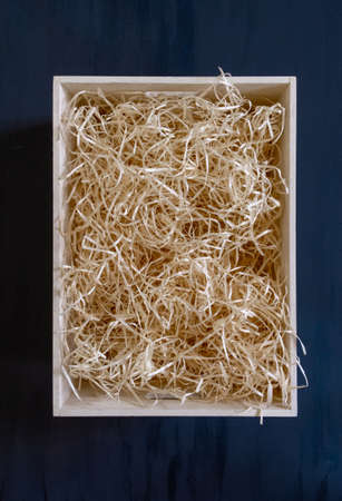 Straw into storage box for wine on the blue background, delivery service.の写真素材