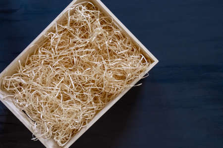 Straw into storage box for wine on the blue background, delivery service.の写真素材