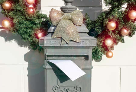 A letter in old-fashioned mailbox near house on the eve New Year. Letter to Santa Claus conceptの写真素材