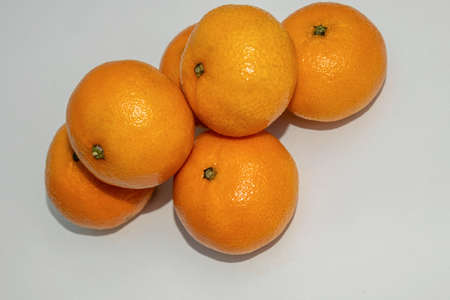 A Lot of Orange tangerines on the white background with flash.の写真素材