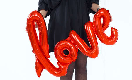 Female hands Holding Red Letters Love for party Valentine's day on the white background.の写真素材