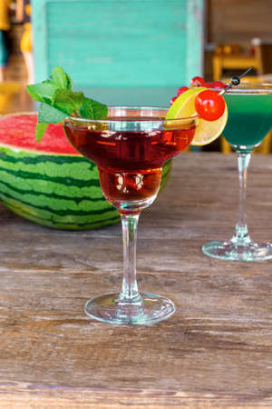 Cocktail Woowoo cherry, lime, mint, cranberry juice and vodka with watermelon on the old wooden table.の写真素材