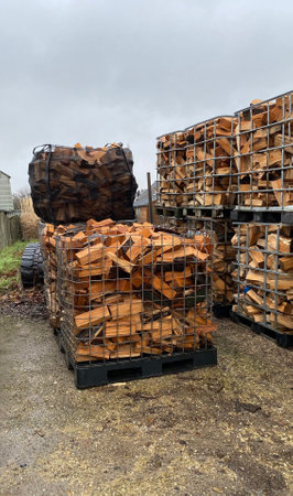 Many Prepared containers with Firewood for sale in storage outside. Package warehouse on the production and procurement of firewood.の写真素材