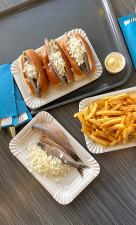 Dutch herring with onions and a bun is a typical national food in the Netherlands, beach cafe, top view.の写真素材