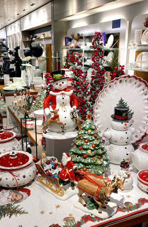 A lot of New Year's porcelain toys in a vintage style, Santa Klaus, snowman, plates and a deer in a supermarket on the Christmas Sale. Bijenkorf.の写真素材