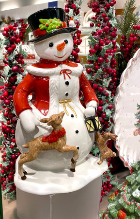 A lot of New Year's porcelain toys in a vintage style, Santa Klaus, snowman, plates and a deer in a supermarket on the Christmas Sale. Bijenkorf.の写真素材