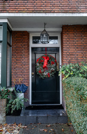 A typical festive wreath on a front door in the Netherlands during Christmas and New Year celebrations.の写真素材