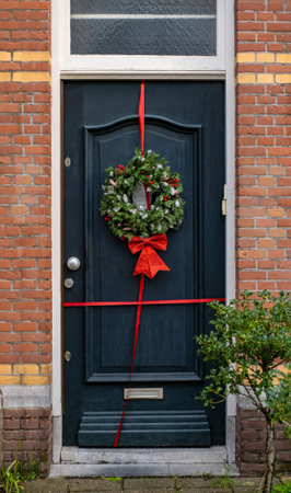 A typical festive wreath on a front door in the Netherlands during Christmas and New Year celebrations.の写真素材
