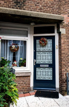 Typical festive decorations on the front door of a house and windows in the Netherlands during the Christmas and New Year celebrationsの写真素材