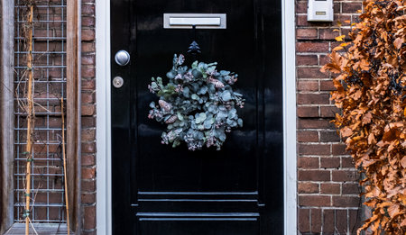 A typical festive wreath on a front door in the Netherlands during Christmas and New Year celebrations.の写真素材