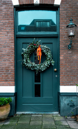 A typical festive wreath on a front door in the Netherlands during Christmas and New Year celebrations.の写真素材