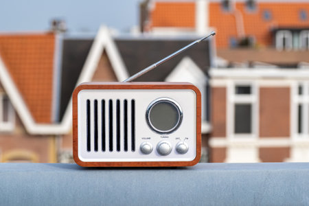 Old-fashioned vintage radio stands on the street against the backdrop of the sky and housesの写真素材