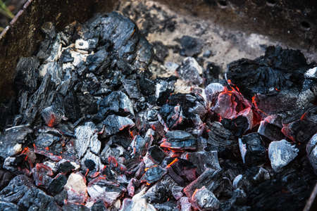 Burning grill coals in an iron grill.の写真素材