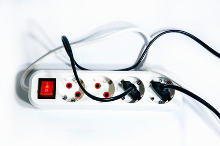 Extension cord with a button on a white background. Isolate. Copy space.View from above. Flat lay.