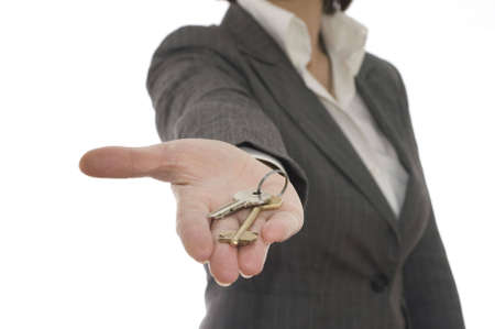 the young businesswoman hold the key in the handの写真素材