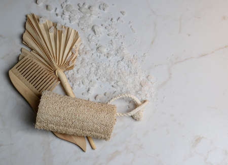 Wooden items for body care and hair on a marble background. Relaxation in the spa salon. Meditation and body care. pleasure items, bath salts, body clay. means for relaxation and recovery. organic products for the body. natural remedies.の写真素材