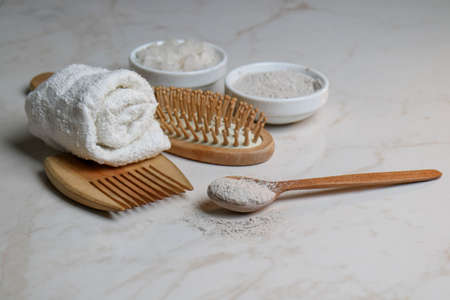 Wooden items for body care and hair on a marble background. Relaxation in the spa salon. Meditation and body care. pleasure items, bath salts, body clay. means for relaxation and recovery. organic products for the body. natural remedies.の写真素材