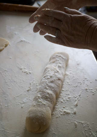 dough and flour on the table. cooking gingerbread. knead the dough to make a pie. grandmother prepares a cupcake. mom makes sweets.の写真素材