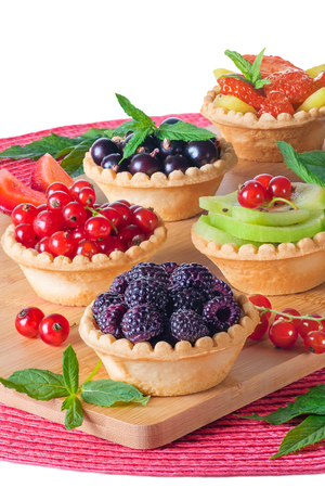 Tartlets with a stuffing of red currant, black currant, blackberry, strawberry, kiwi. Homemade summer healthy dessert.の写真素材