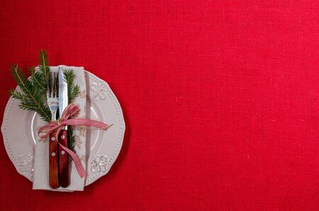 The plate is empty. Napkin. A sprig of Holly. Cutlery. A festive table setting. Christmas. Christmas...